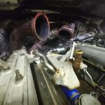Looking at Engine Parts Under Lifted Hood